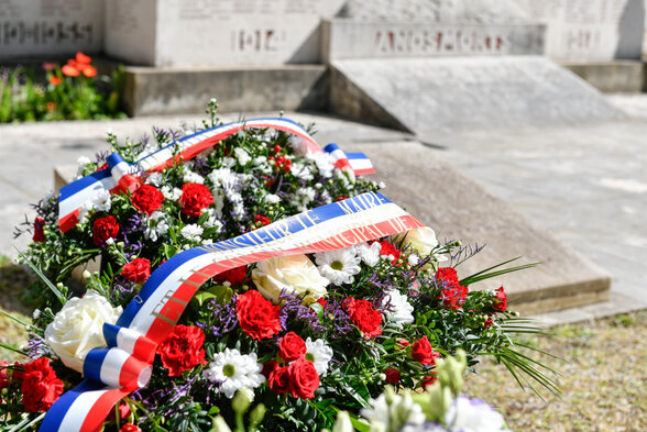 Gerbe tricolore fleurie portant le ruban du Conseil municipal, déposée au pied du monument aux Morts - Agrandir l'image, fenêtre modale